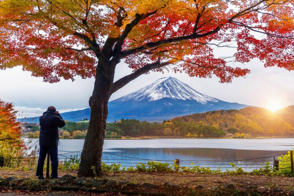 Photographer capturing Mount Fuji in autumn