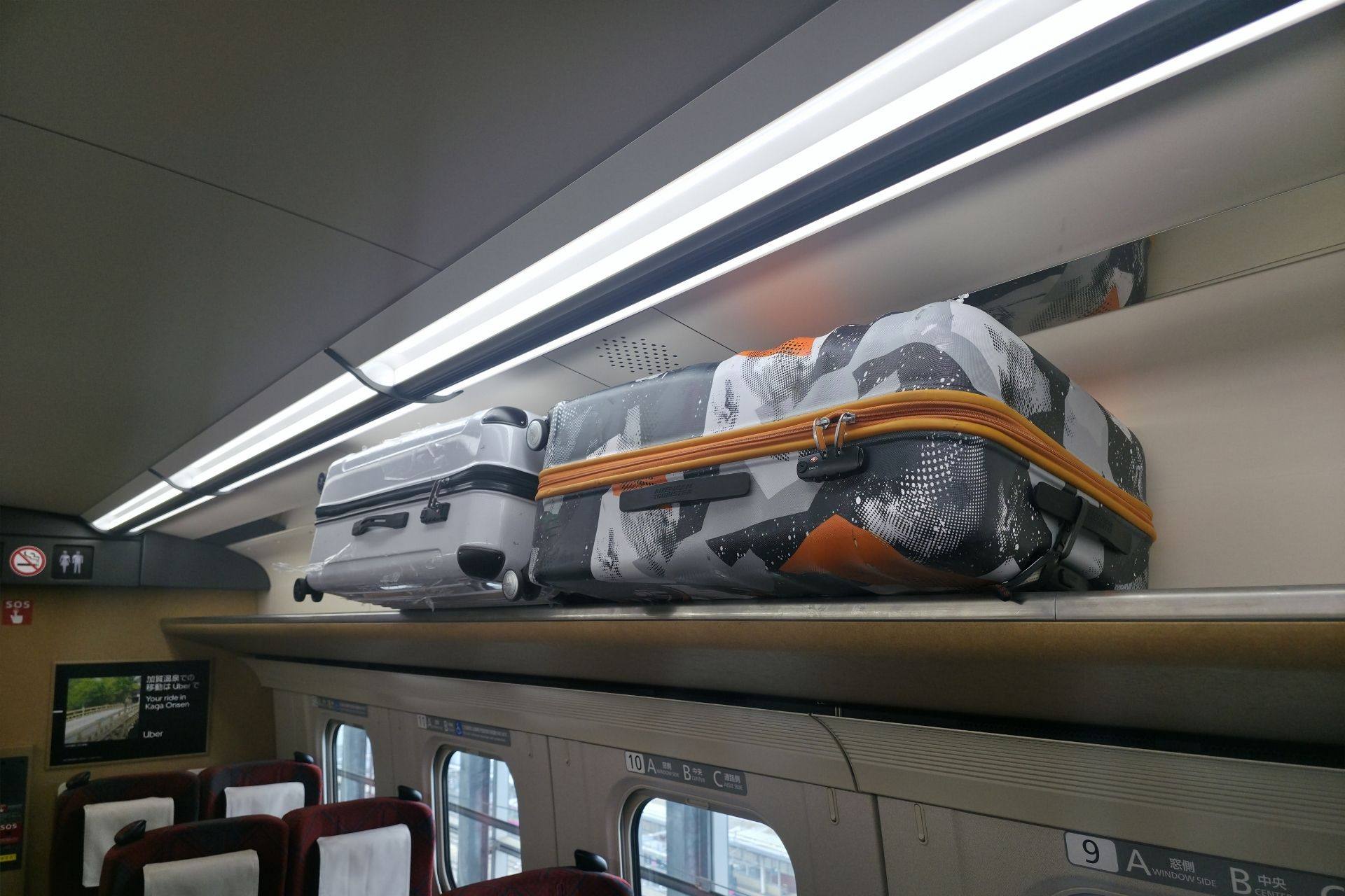 Luggage stored on Shinkansen overhead rack