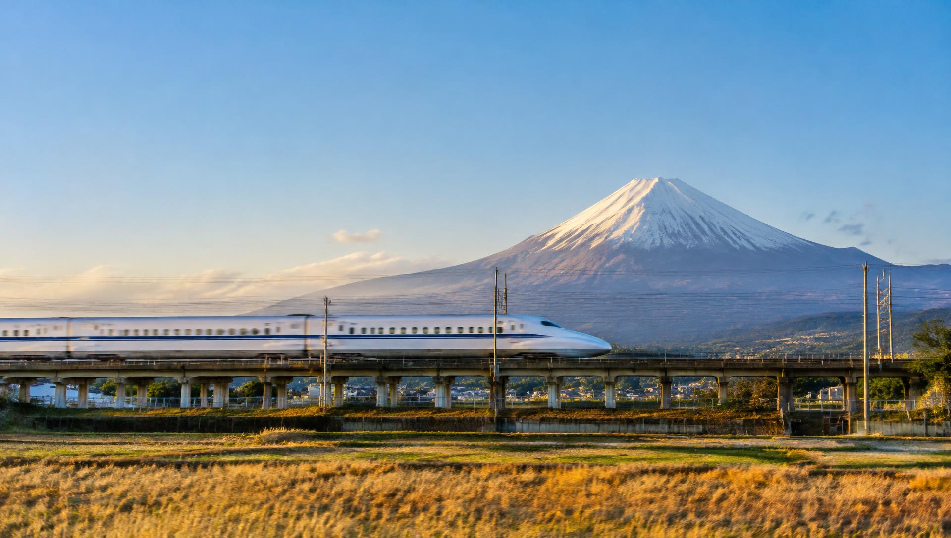 Shinkansen bullet train passing Mount Fuji in Japan
